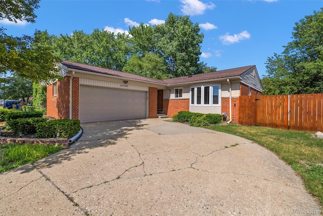 26250 Virginia Dr, Warren, MI 48091 - view of front of property featuring brick siding, a garage, and concrete driveway