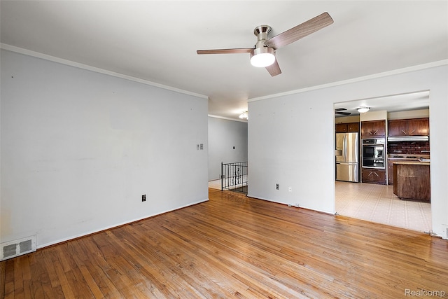 26250 Virginia Dr, Warren, MI 48091 - unfurnished living room featuring crown molding, ceiling fan, and light wood-type flooring