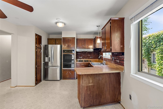 26250 Virginia Dr, Warren, MI 48091 - kitchen featuring black appliances, tasteful backsplash, light countertops, light floors, and a peninsula