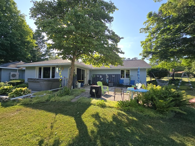 971 Weaver Rd, Bronson, MI 49028 - back of house featuring a hot tub, a lawn, and a patio