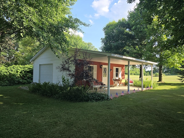 971 Weaver Rd, Bronson, MI 49028 - rear view of house featuring a yard, a garage, and covered porch