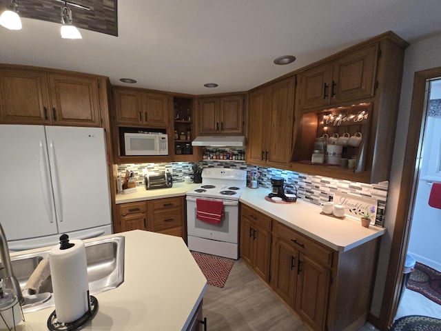 971 Weaver Rd, Bronson, MI 49028 - kitchen featuring white appliances, under cabinet range hood, open shelves, backsplash, and recessed lighting