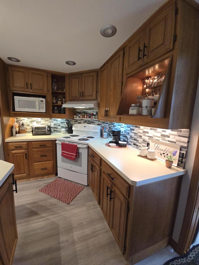971 Weaver Rd, Bronson, MI 49028 - kitchen featuring white appliances, open shelves, tasteful backsplash, and under cabinet range hood