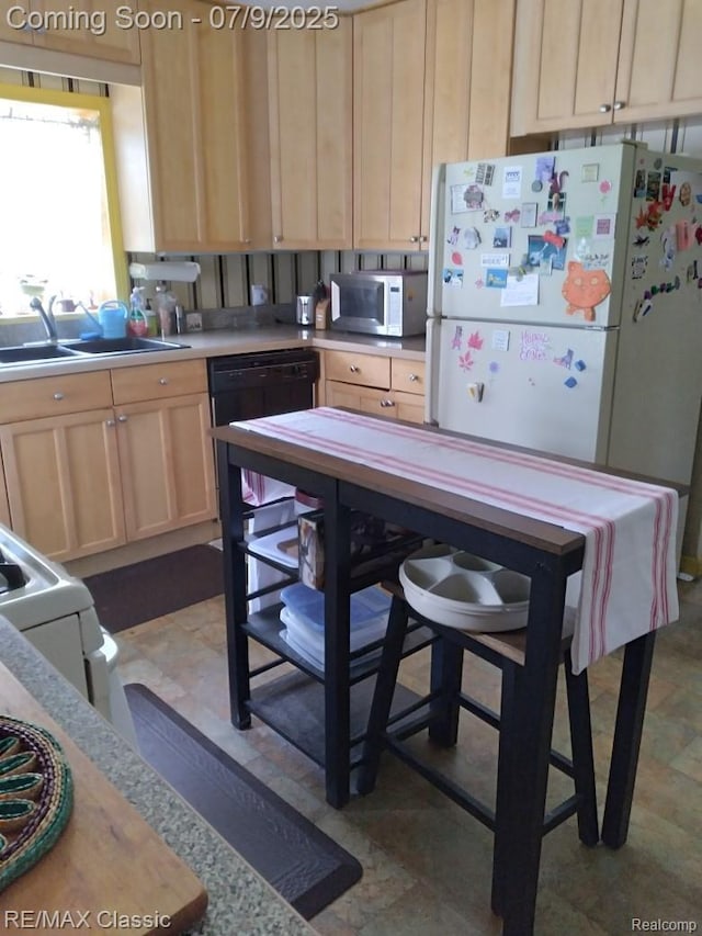 18404 Deering St, Livonia, MI 48152 - kitchen with white appliances, light brown cabinetry, and light countertops