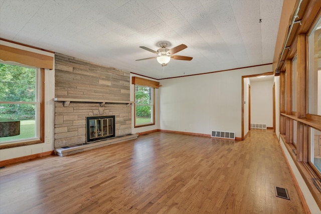 1834 Bond St, Niles, MI 49120 - unfurnished living room featuring light wood-style floors, ceiling fan, a fireplace, and ornamental molding