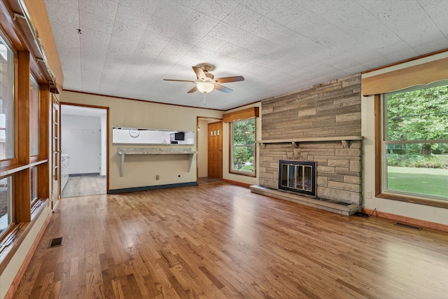1834 Bond St, Niles, MI 49120 - unfurnished living room featuring a ceiling fan, wood finished floors, and a fireplace