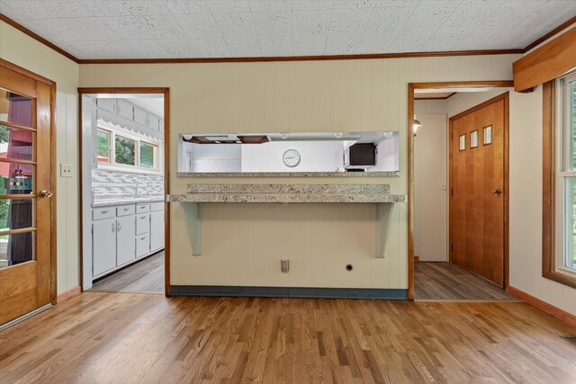 1834 Bond St, Niles, MI 49120 - kitchen featuring ornamental molding, light wood-type flooring, and light countertops