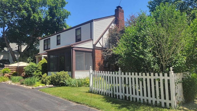 401 Budlong St, Adrian, MI 49221 - view of front of property with a sunroom and a chimney