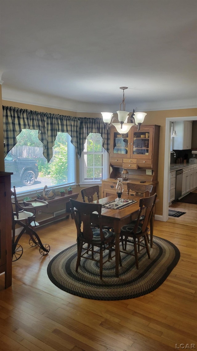 401 Budlong St, Adrian, MI 49221 - dining room with light wood-type flooring and a chandelier