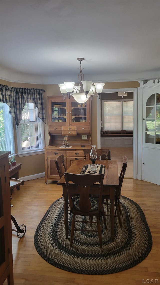 401 Budlong St, Adrian, MI 49221 - dining room featuring a chandelier and light wood finished floors