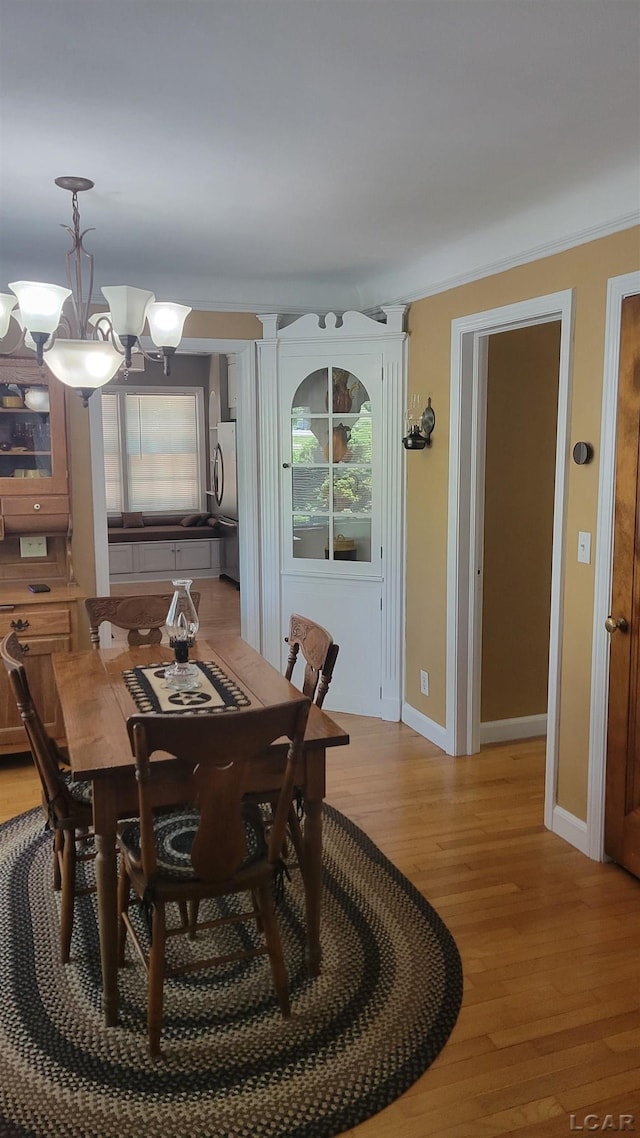 401 Budlong St, Adrian, MI 49221 - dining space featuring a chandelier, light wood finished floors, and healthy amount of natural light