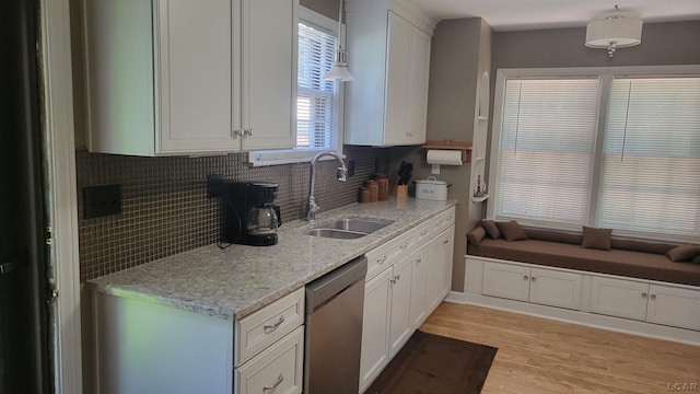 401 Budlong St, Adrian, MI 49221 - kitchen with dishwasher, tasteful backsplash, white cabinets, light wood-style floors, and light stone counters