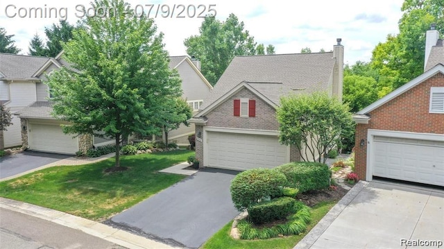 5348 Forest Ridge Dr, Clarkston, MI 48346 - view of front facade featuring brick siding, a front lawn, a chimney, and a garage