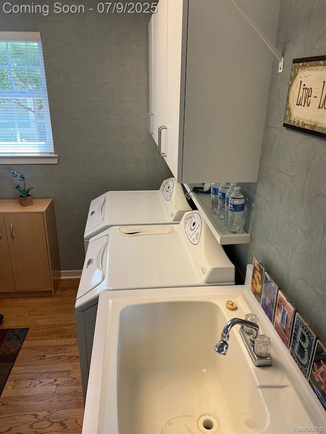 5348 Forest Ridge Dr, Clarkston, MI 48346 - laundry room with wood finished floors and washing machine and clothes dryer
