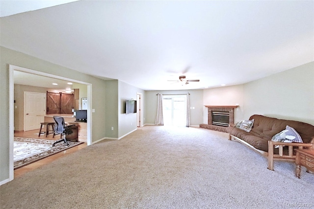 9100 Mayfred Dr, Pinckney, MI 48169 - living room with carpet, an office area, a ceiling fan, a fireplace, and recessed lighting
