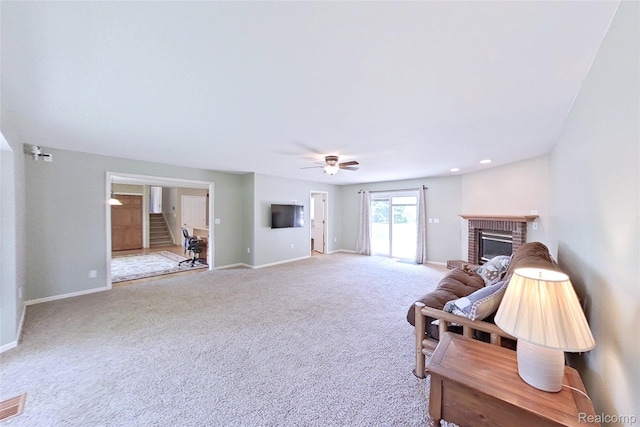 9100 Mayfred Dr, Pinckney, MI 48169 - living area with a fireplace, carpet, and ceiling fan