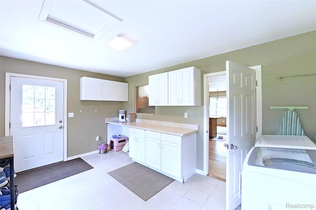 9100 Mayfred Dr, Pinckney, MI 48169 - kitchen featuring healthy amount of natural light, white cabinets, light countertops, and independent washer and dryer