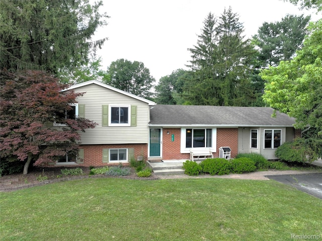 9100 Mayfred Dr, Pinckney, MI 48169 - view of front facade with a front lawn and brick siding