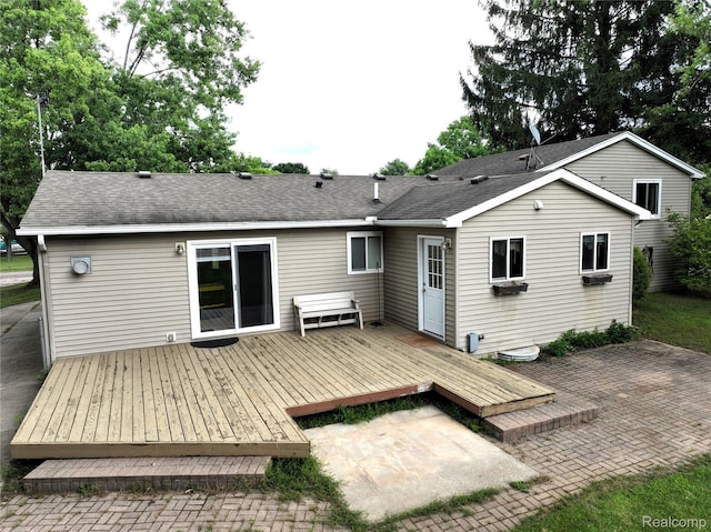 9100 Mayfred Dr, Pinckney, MI 48169 - rear view of house with a patio, a wooden deck, and a shingled roof