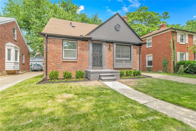 3992 Devonshire Rd, Detroit, MI 48224 - bungalow-style home featuring brick siding, a front lawn, a chimney, and roof with shingles