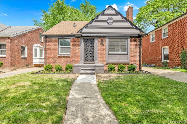 3992 Devonshire Rd, Detroit, MI 48224 - bungalow-style house featuring brick siding, a front lawn, and a chimney