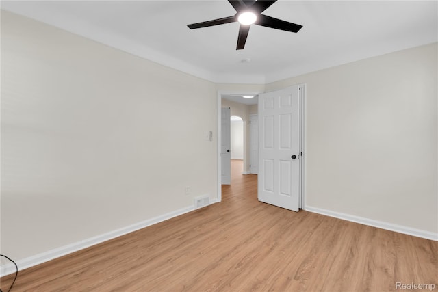 3992 Devonshire Rd, Detroit, MI 48224 - unfurnished room featuring light wood-type flooring, a ceiling fan, and arched walkways