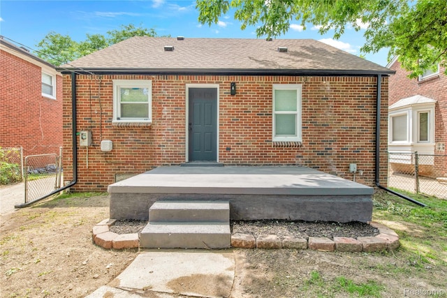3992 Devonshire Rd, Detroit, MI 48224 - back of house featuring roof with shingles and brick siding