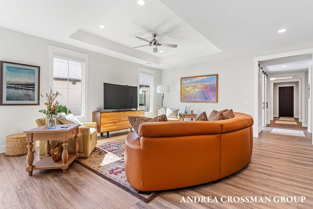 2063 Ottawa Beach Rd, Holland, MI 49424 - living area with light wood-type flooring, a raised ceiling, a ceiling fan, and recessed lighting
