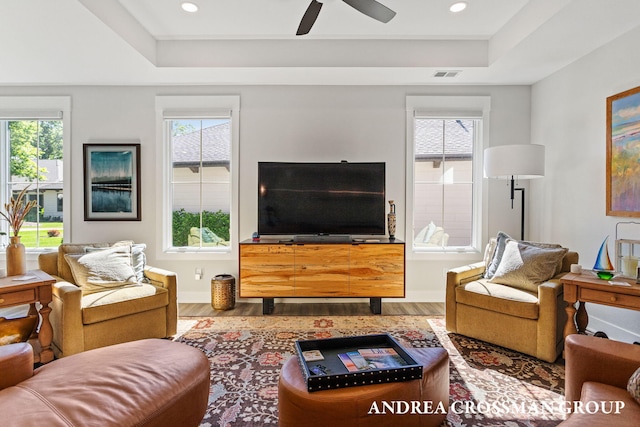 2063 Ottawa Beach Rd, Holland, MI 49424 - living area featuring a tray ceiling, wood finished floors, a ceiling fan, and recessed lighting