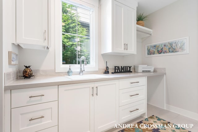 2063 Ottawa Beach Rd, Holland, MI 49424 - kitchen with white cabinets, light countertops, light tile patterned flooring, and open shelves