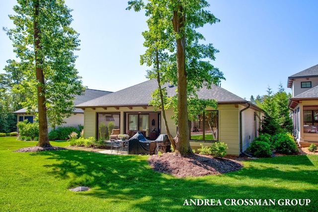 2063 Ottawa Beach Rd, Holland, MI 49424 - back of house featuring a lawn, an outdoor hangout area, a shingled roof, and a patio area