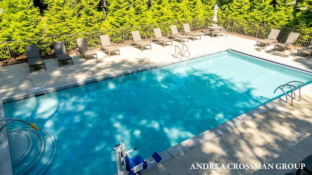 2063 Ottawa Beach Rd, Holland, MI 49424 - community pool featuring a patio and a view of trees