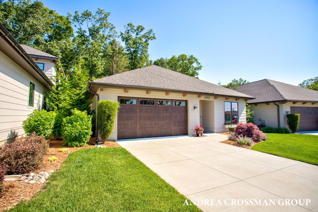2063 Ottawa Beach Rd, Holland, MI 49424 - view of front of property with concrete driveway, a garage, a front yard, and a shingled roof