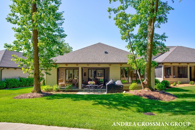 2063 Ottawa Beach Rd, Holland, MI 49424 - rear view of property with a yard, a patio area, and roof with shingles