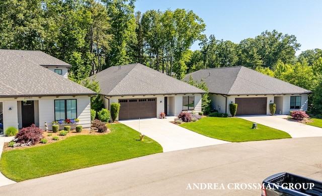2063 Ottawa Beach Rd, Holland, MI 49424 - view of front of home featuring roof with shingles, a front yard, driveway, and a garage