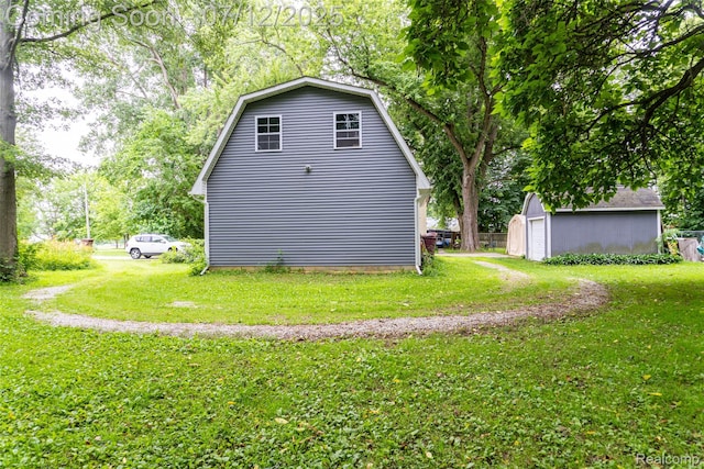 16380 Sumpter Rd, Van Buren, MI 48111 - view of home's exterior featuring an outbuilding, a lawn, and a gambrel roof