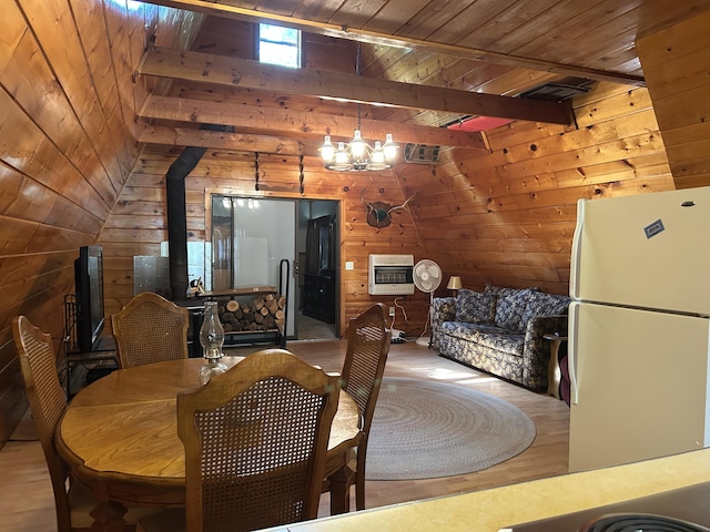 3423 S James Rd, Baldwin, MI 49304 - dining room with wood walls, heating unit, wood ceiling, wood finished floors, and a chandelier