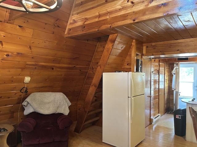 3423 S James Rd, Baldwin, MI 49304 - kitchen with freestanding refrigerator, wood walls, a baseboard heating unit, light wood-type flooring, and lofted ceiling
