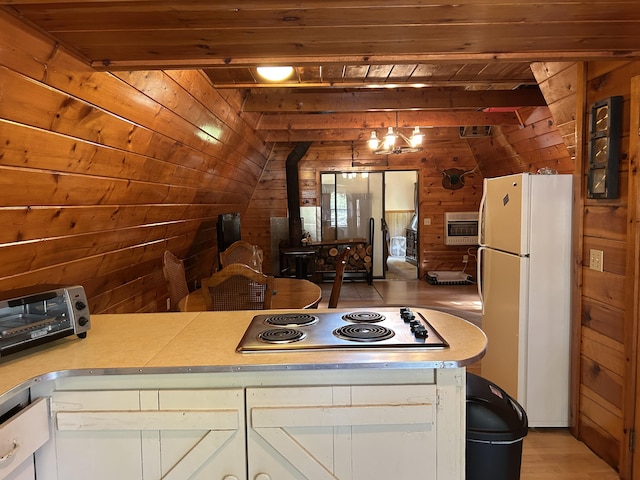 3423 S James Rd, Baldwin, MI 49304 - kitchen with freestanding refrigerator, wood walls, stainless steel electric cooktop, light countertops, and wooden ceiling