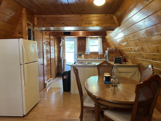 3423 S James Rd, Baldwin, MI 49304 - dining area with a baseboard heating unit, wooden walls, light wood finished floors, and wood ceiling