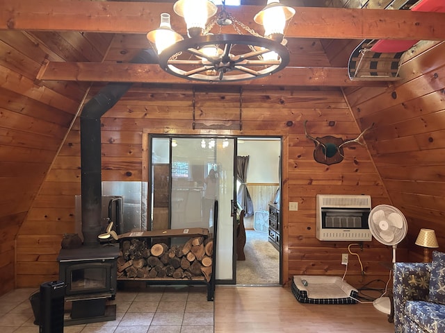 3423 S James Rd, Baldwin, MI 49304 - living area featuring heating unit, wood walls, a wood stove, wood ceiling, and a chandelier