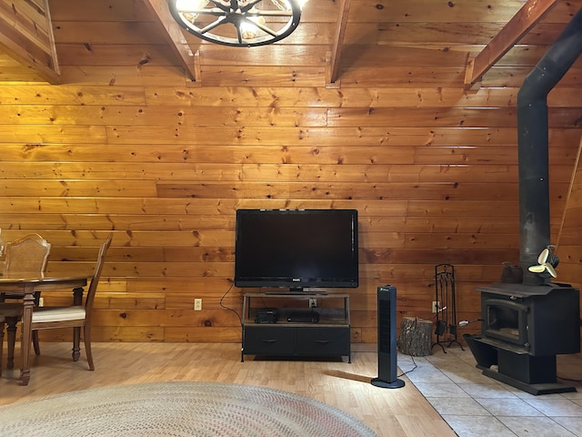 3423 S James Rd, Baldwin, MI 49304 - living room with a wood stove, wood finished floors, wooden ceiling, and wood walls