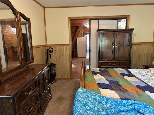 3423 S James Rd, Baldwin, MI 49304 - bedroom featuring wooden walls, wainscoting, freestanding refrigerator, carpet floors, and crown molding