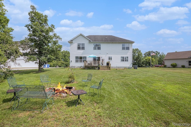 5304 Boomerang Cir, Newport, MI 48166 - back of property with a fire pit, a deck, and a yard