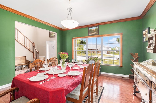 5304 Boomerang Cir, Newport, MI 48166 - dining room featuring hardwood / wood-style floors, crown molding, and stairs