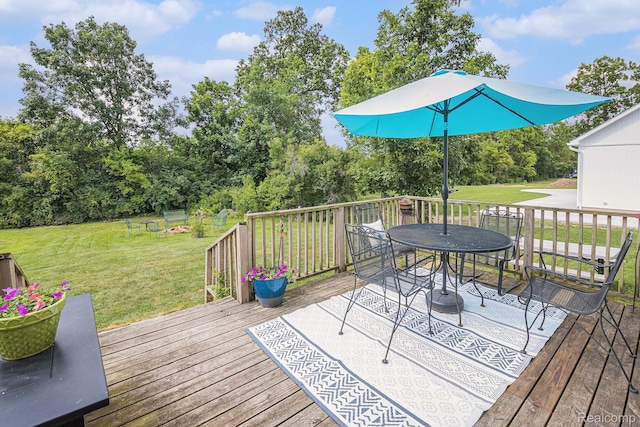 5304 Boomerang Cir, Newport, MI 48166 - deck featuring a lawn, outdoor dining area, and view of wooded area