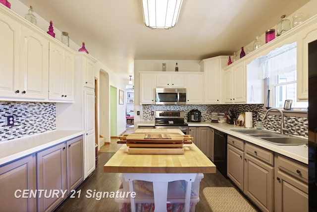 3405 S Miller Rd, Saginaw, MI 48609 - kitchen with stainless steel appliances, butcher block countertops, backsplash, and dark wood-style floors