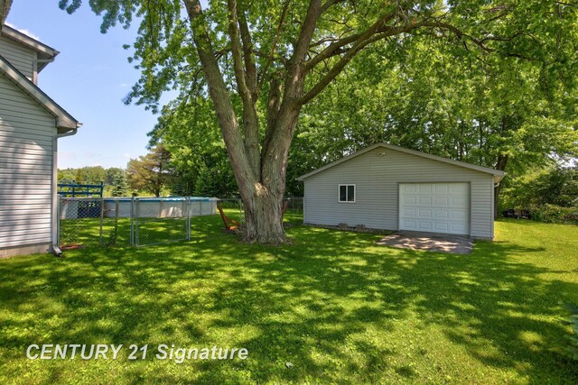 3405 S Miller Rd, Saginaw, MI 48609 - view of yard with a detached garage, an outdoor structure, and view of scattered trees