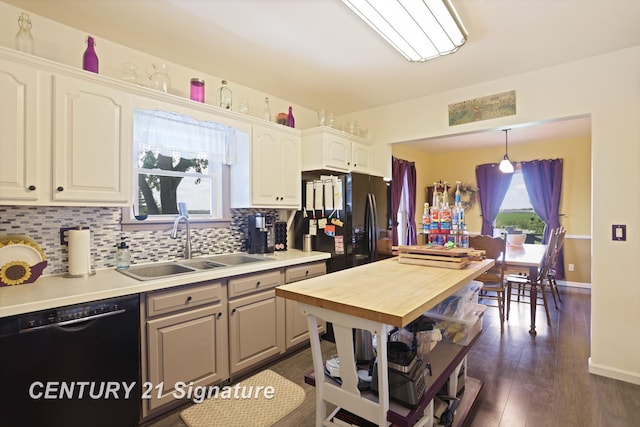 3405 S Miller Rd, Saginaw, MI 48609 - kitchen featuring black appliances, decorative backsplash, dark wood-type flooring, decorative light fixtures, and white cabinetry