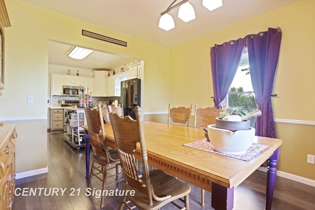3405 S Miller Rd, Saginaw, MI 48609 - dining room featuring dark wood-type flooring and baseboards